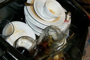 Dirty dishes in a restaurant kitchen illustrating background garbage collection – the flash system must keep recycling stale pages or user I/O will be forced to wait