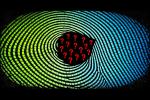 Fingerprint rendered in glowing white ridge lines on a black background, with a void at its centre where the pattern is simply absent